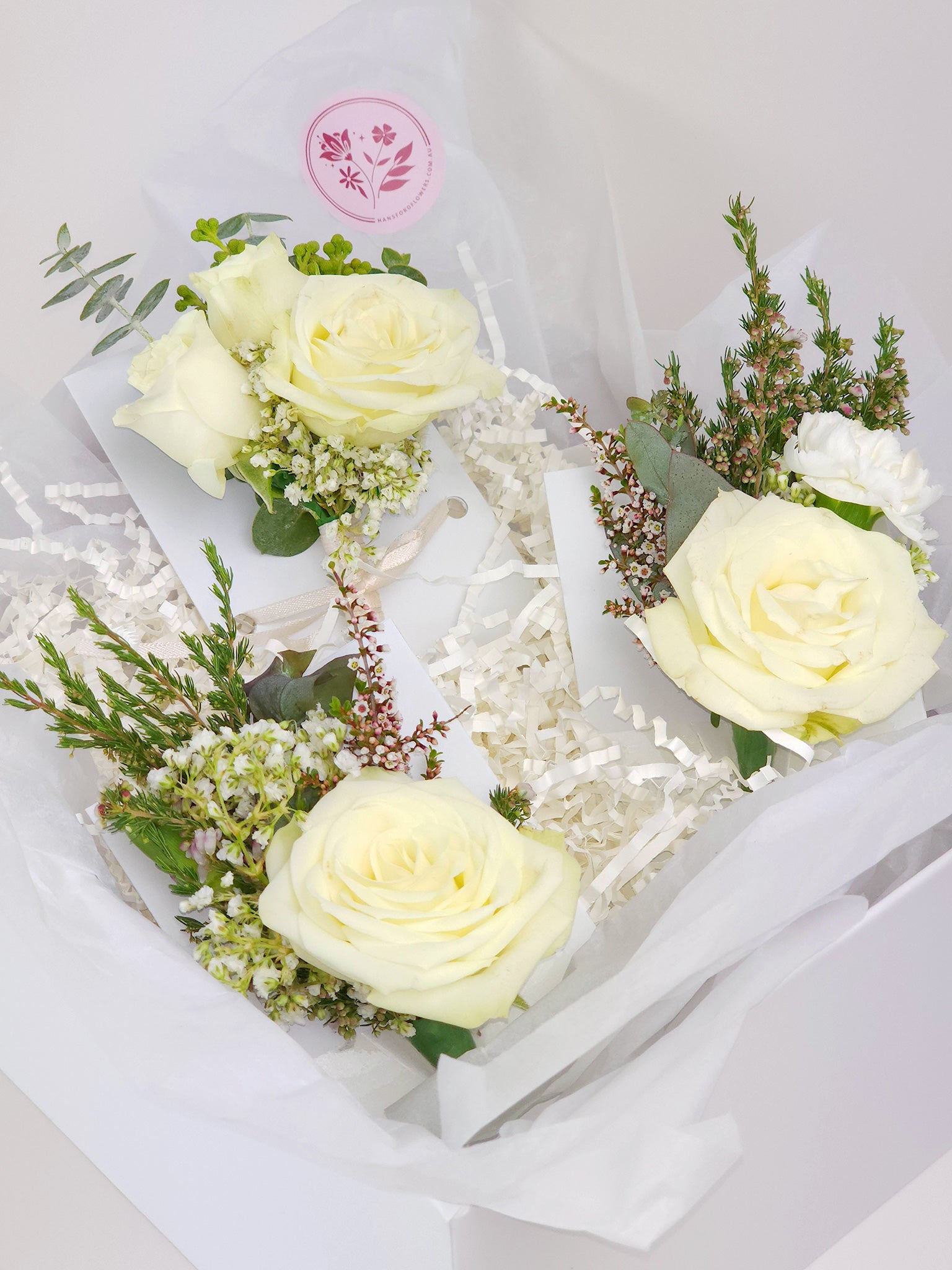 Three White rose buttonholes